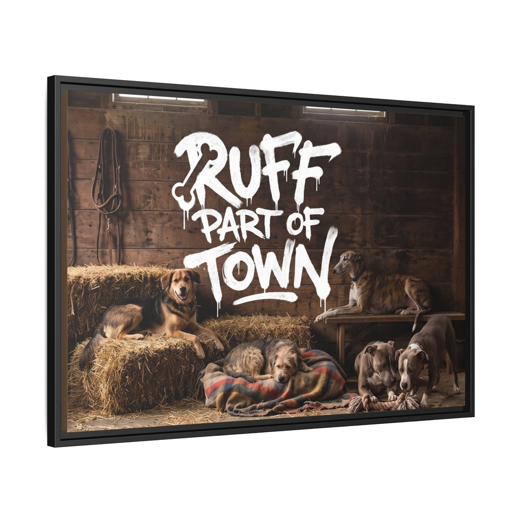 Ruff Part of Town framed canvas art featuring a group of dogs resting in a barn with hay bales and a wooden bench. White graffiti-style text reads "RUFF PART OF TOWN".