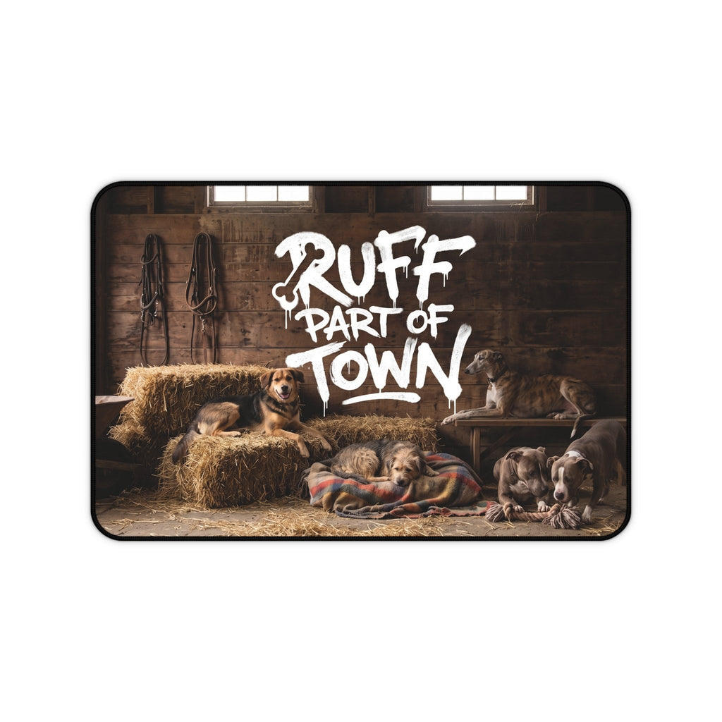 Ruff Part of Town desk mat featuring dogs resting on hay bales and blankets in a rustic barn. Neoprene surface.