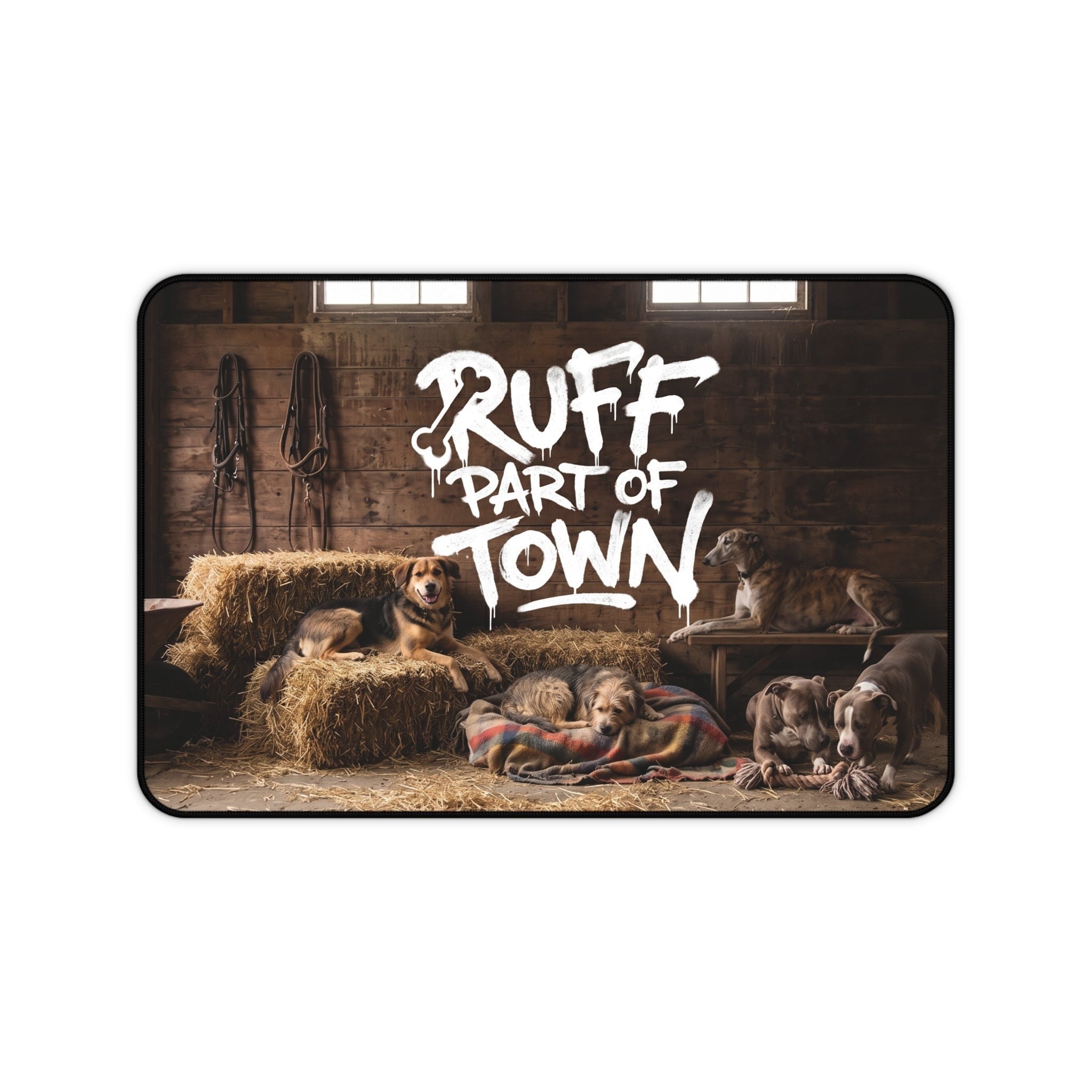Ruff Part of Town desk mat featuring dogs resting on hay bales and blankets in a rustic barn. Neoprene surface.