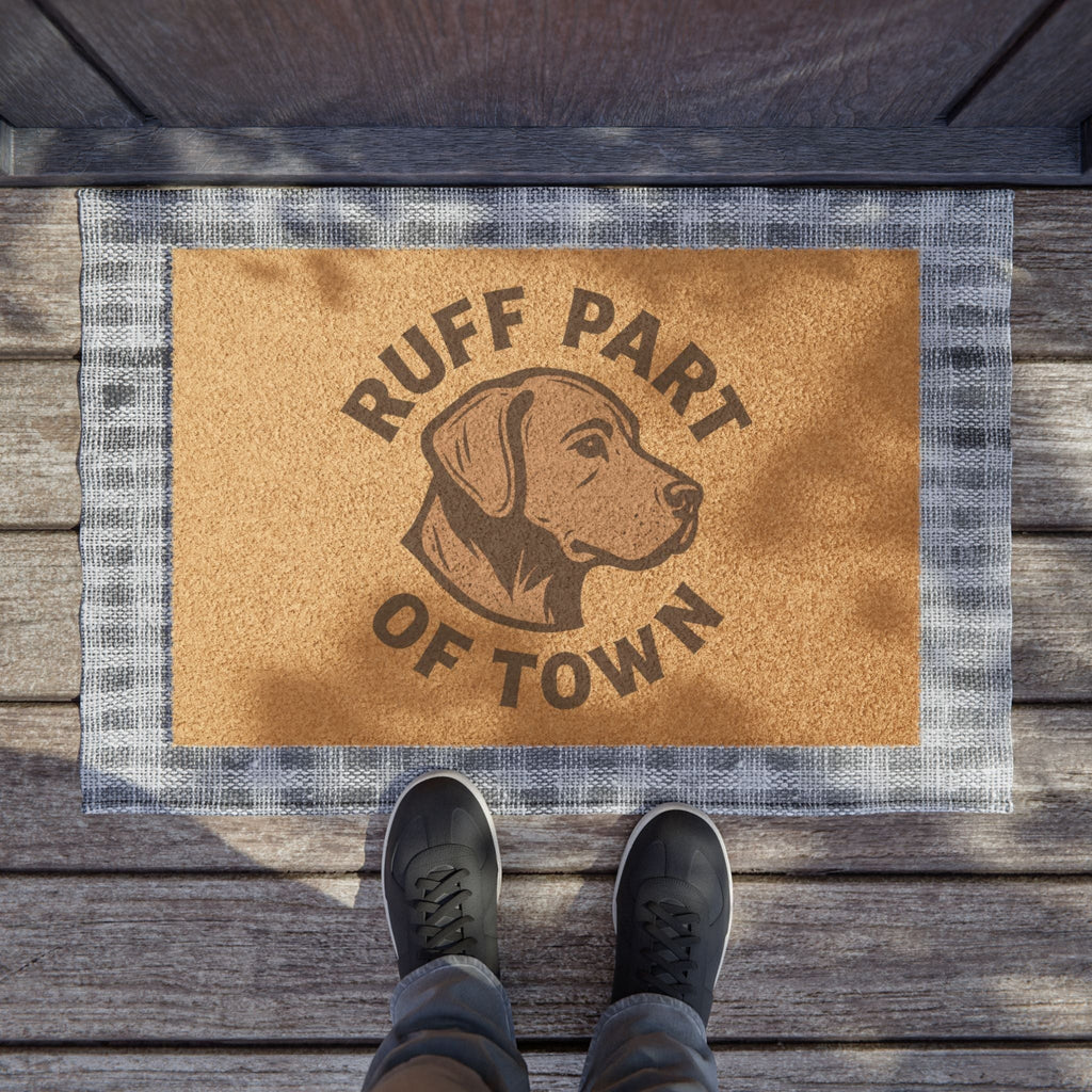 Ruff Part of Town coir doormat with dog graphic and plaid border. Natural coir fiber with black vinyl backing.