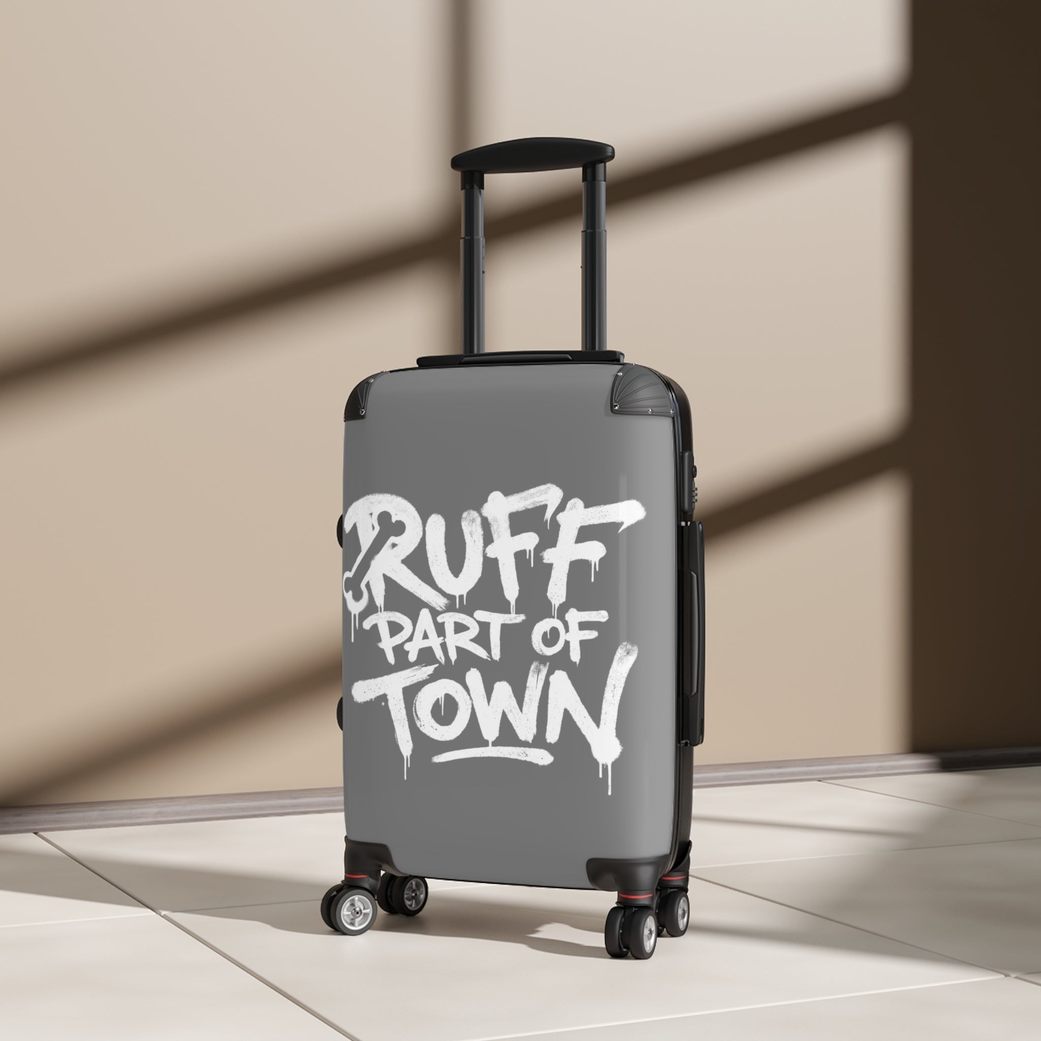 Ruff Part of Town grey hard-shell carry-on suitcase with graffiti print and black telescopic handle.