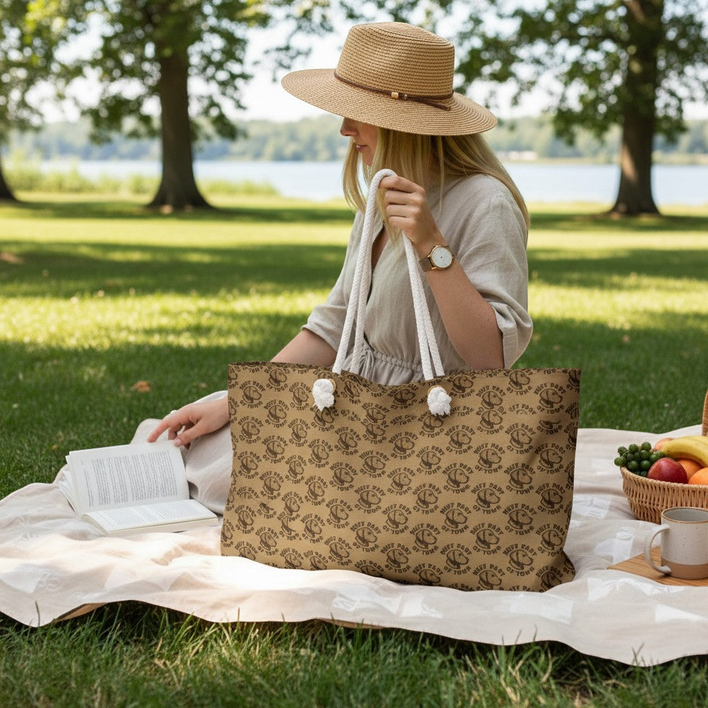 Ruff Part of Town logo pattern weekender bag with cream rope handles and gold-tone grommets, perfect for travel.