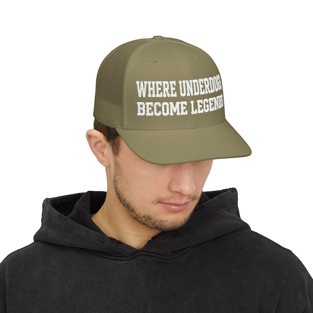 Ruff Part of Town olive green trucker cap with white distressed text "WHERE UNDERDOGS BECOME LEGENDS" on front panel. Mesh back for breathability.