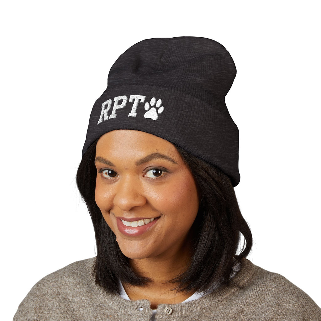 Ruff Part of Town dark grey cuffed acrylic beanie with white RPT and paw embroidery, worn by a smiling woman.