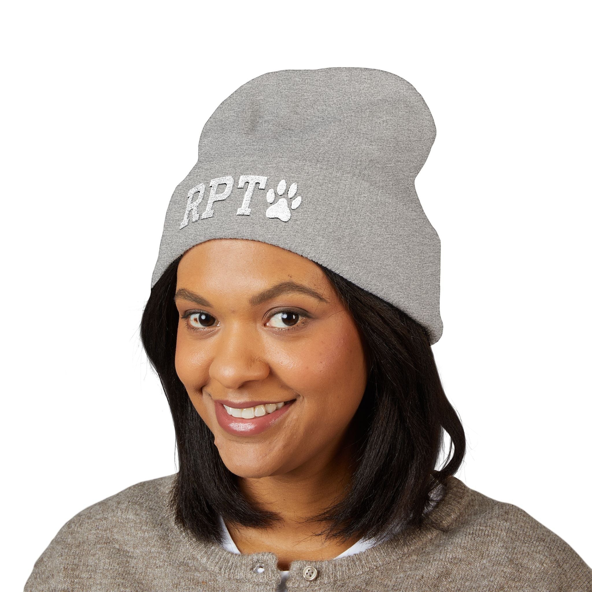 Ruff Part of Town grey acrylic cuffed beanie with white RPT and paw embroidery. Model wears it with a neutral cardigan.