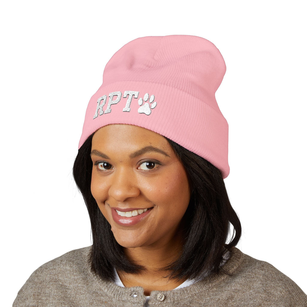 Ruff Part of Town pink cuffed acrylic beanie with embroidered RPT and paw accent. Model wears a grey cardigan.